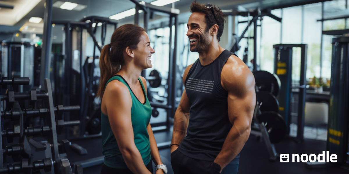 A man and a woman stnad in a gym. 